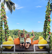 kids with arms up having fun in Bali, surrounded by tropical nature