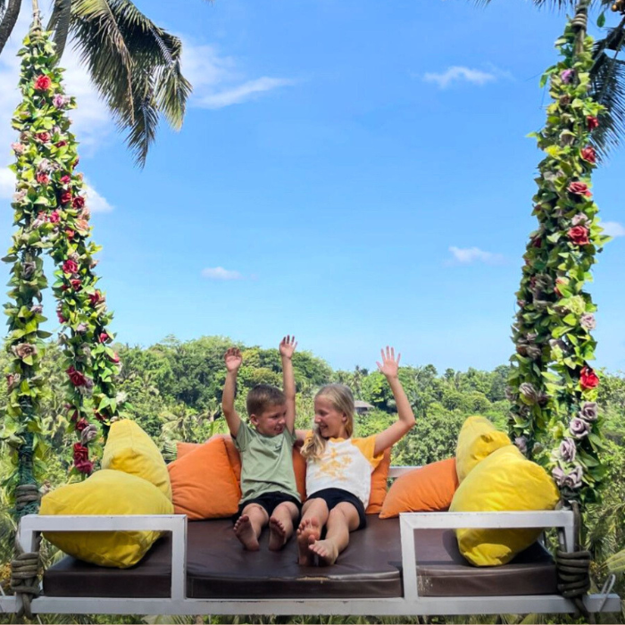 kids with arms up having fun in Bali, surrounded by tropical nature